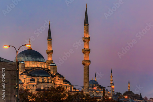 The Yeni Cami or New Mosque illuminated in the morning at sunrise on the Historic Peninsula in Istanbul, Turkey