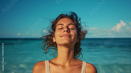 woman outdoors with a serene expression on her face, enjoying the moment, beach backdrop relaxed summer happy fresh air