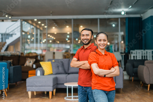 man and woman with crossed hands standing in front of furniture store department
