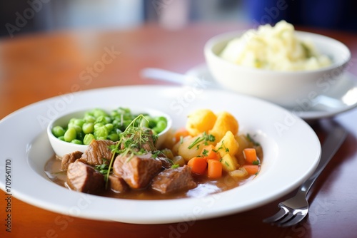 beef stew meal, side of green peas and mashed potatoes