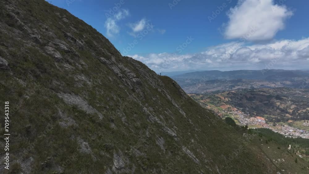 A man standing on a rugged mountain in the Andes. Aerial view A man standing on a rugged mountain in the Andes. Aerial view