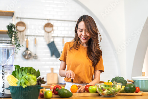 Portrait of beauty body slim healthy asian woman eating vegan food healthy with fresh vegetable salad in kitchen at home.diet  vegetarian  fruit  wellness  health  green food.Fitness and healthy food