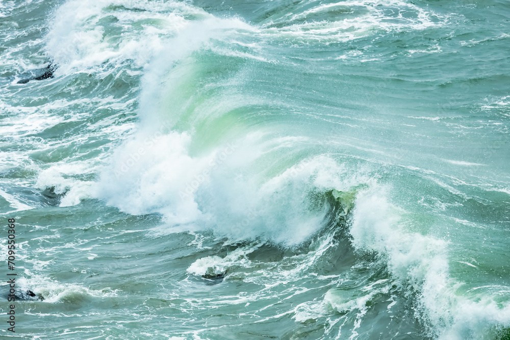 Wave splashing close-up. Crystal clear sea water, in the ocean in San Francisco Bay, blue water, pastel colors.