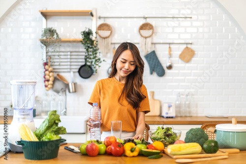 Portrait of beauty body slim healthy asian woman eating vegan food healthy with fresh vegetable salad in kitchen at home.diet  vegetarian  fruit  wellness  health  green food.Fitness and healthy food