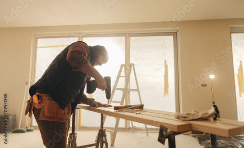 Contractor at work: Home renovation and refurbishment project with general construction worker photo