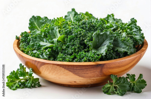 fresh kale in wooden bowl, fresh herbs in a bowl, isolated white background photo