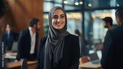 Muslim business woman standing in the office and looking away