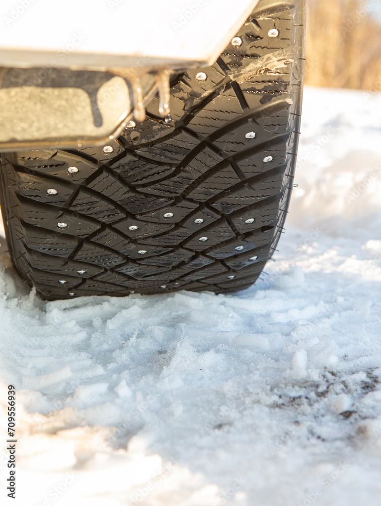 Studded winter tyre on snow.