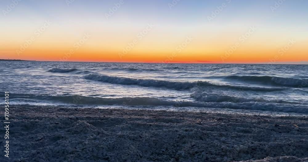relaxing shot of seashells and ocean during sunset relaxing shot of seashells and ocean during sunset