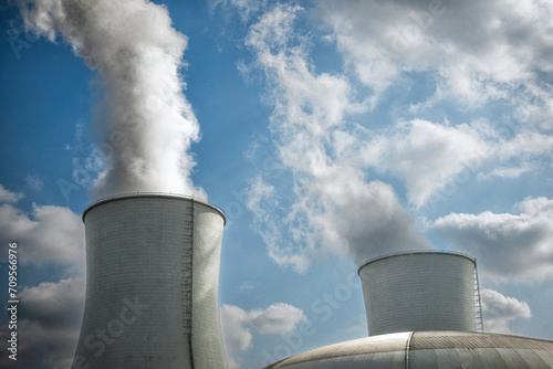 Pair of Cooling Towers at Power Station Against Cloudy Sky