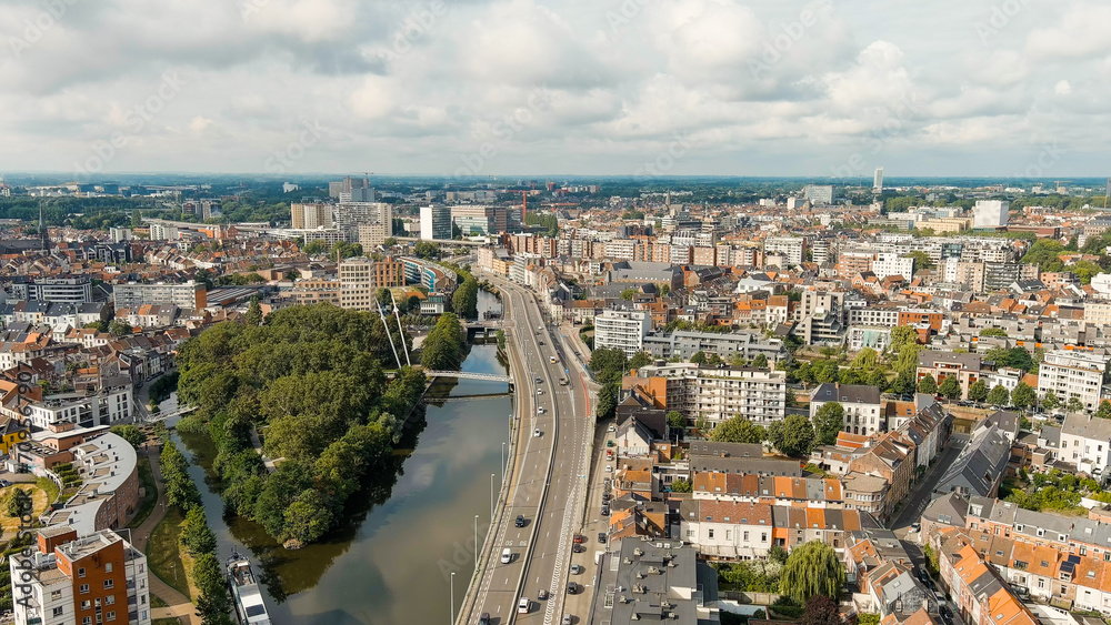Ghent, Belgium. Keizerpark - City park. Esco (Scheldt) river embankment. Panorama of the city from the air. Cloudy weather, summer day, Aerial View