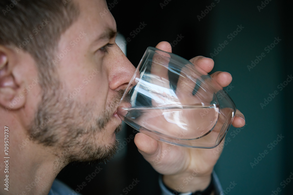 Man drinks water, Close-up shot of bearded man drinking fresh clean water from glass, Quenching thirst, Lifestyle healthcare concept Man drinks water, Close-up shot of bearded man drinking fresh clean water from glass, Quenching thirst, Lifestyle healthcare concept