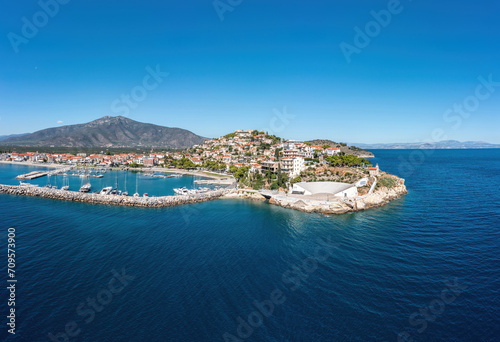 Paralio Astros port, Arcadia, Peloponnese, Greece. Aerial drone view of town, breakwater, boat, sea.