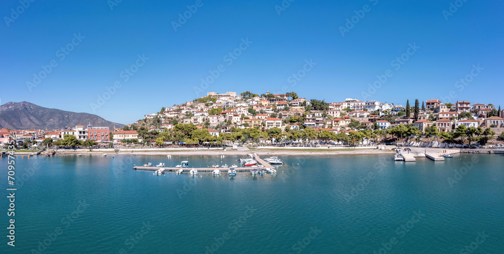 Port Paralio Astros, Arcadia, Peloponnese Greece. Aerial drone panoramic view of town, moored boat.
