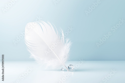 white light feather drop of water blue background