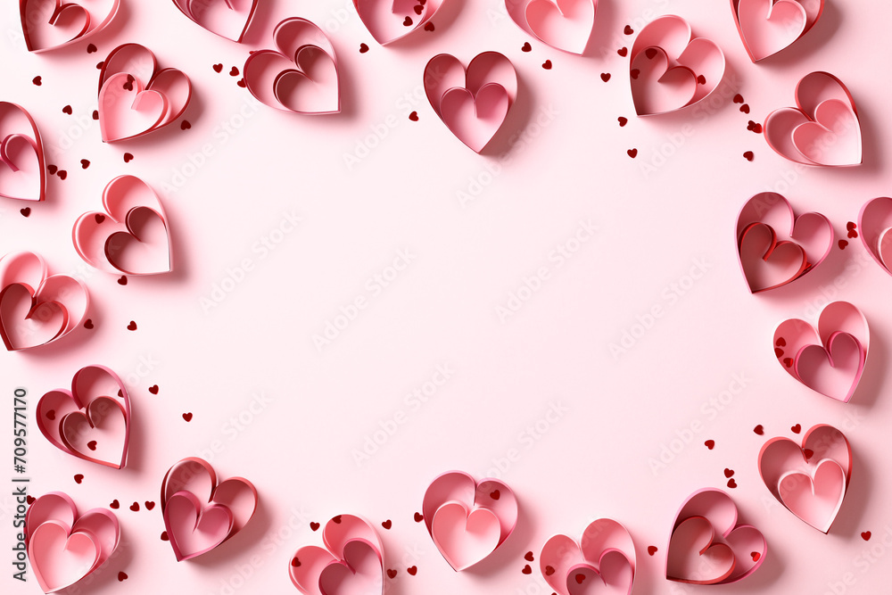 Saint Valentine Day frame of red paper cut hearts on pink background. Flat lay, top view, copy space. Saint Valentine Day frame of red paper cut hearts on pink background. Flat lay, top view, copy space.