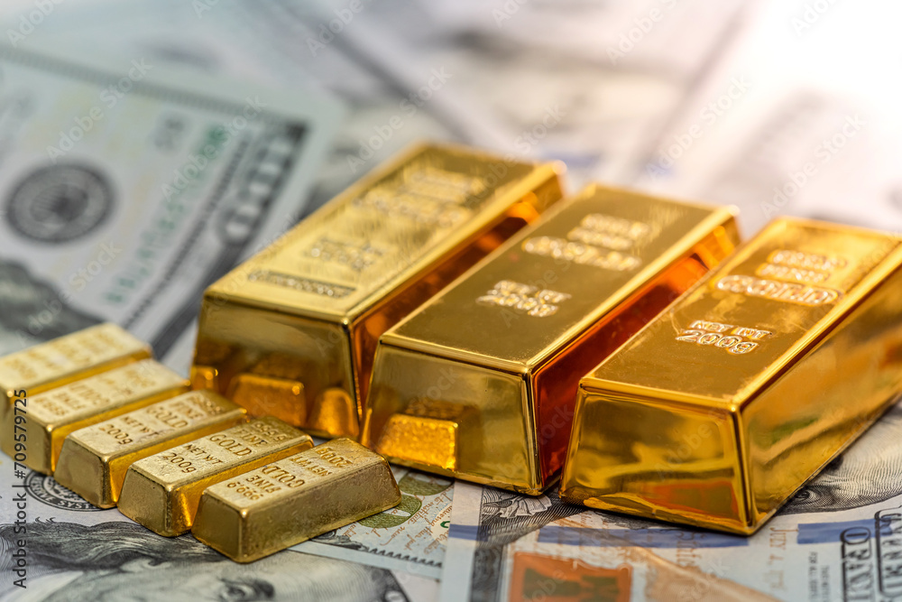 US dollar banknotes with stack od gold bars
