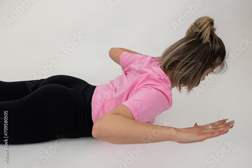 Young woman doing streching exercise, isolated on white background