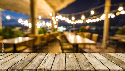 Empty wooden table with a blurred cafe terrace in the background, inviting and ideal for product presentation