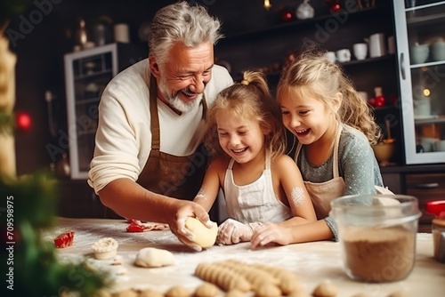 Happy smiling grandfather and granddaughters are baking cookies at home kitchen together