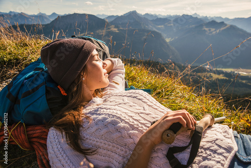 Backpacker resting on mountain in Tannheimer Tal, Tyrol, Austria photo