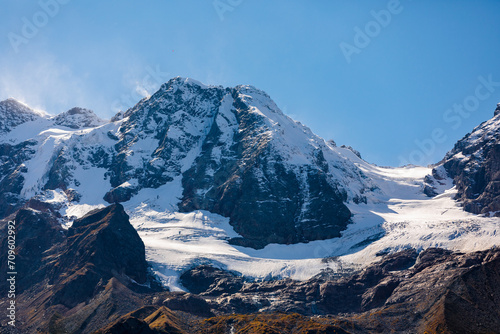 Snow-capped mountains rise majestically along the horizon © ЮРИЙ ПОЗДНИКОВ
