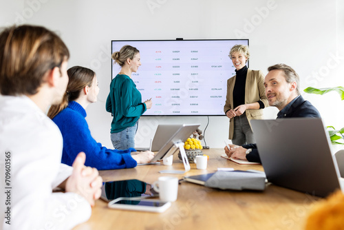 Business colleagues discussing strategy in meeting room at workplace photo
