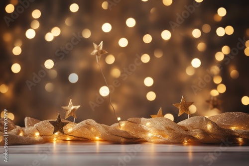  a group of gold stars sitting on top of a table next to a wall covered in golden fabric and a string of lights.