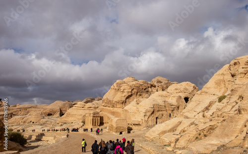 Tourists walking in Petra gorge at very cold winter day.