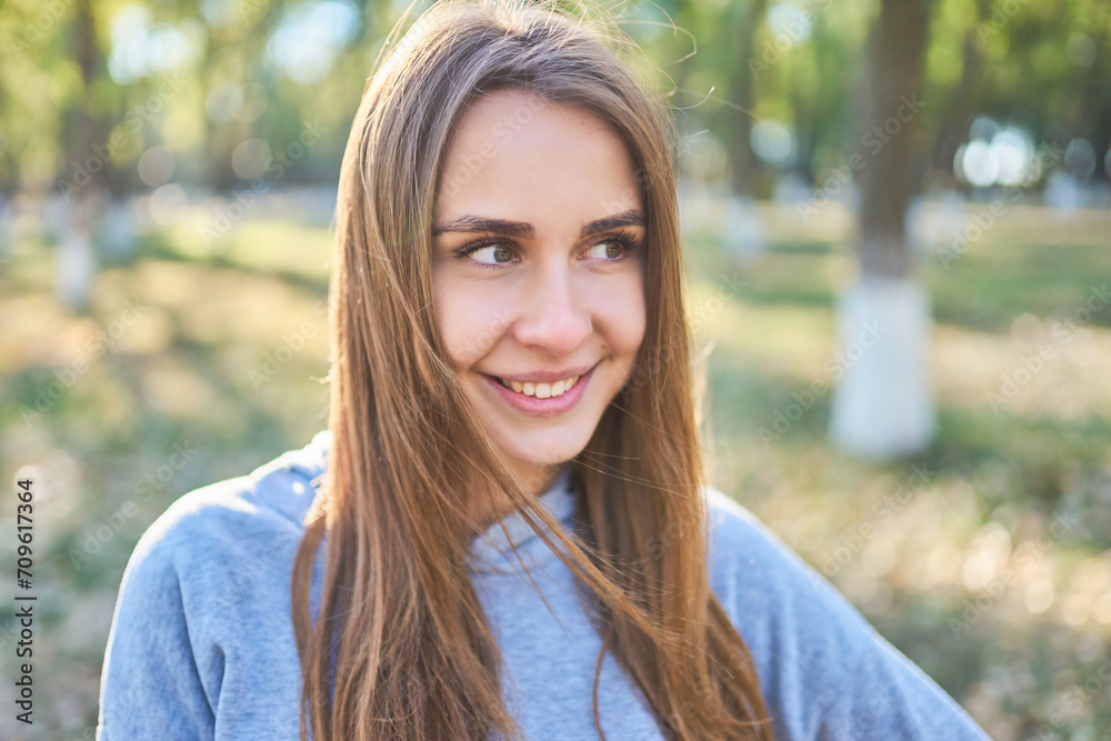 Sunny portrait of smiling girl in park