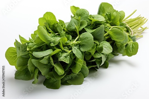  a pile of green leafy vegetables sitting on top of a white table next to a white wall with a white background.