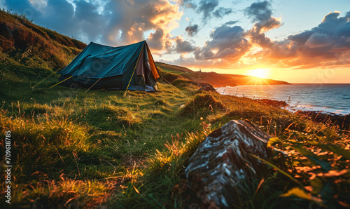 Solitary Tent on a Lush Green Meadow by the Seaside at Sunset, Offering a Peaceful and Scenic Escape into Nature's Serenity and Camping Adventure