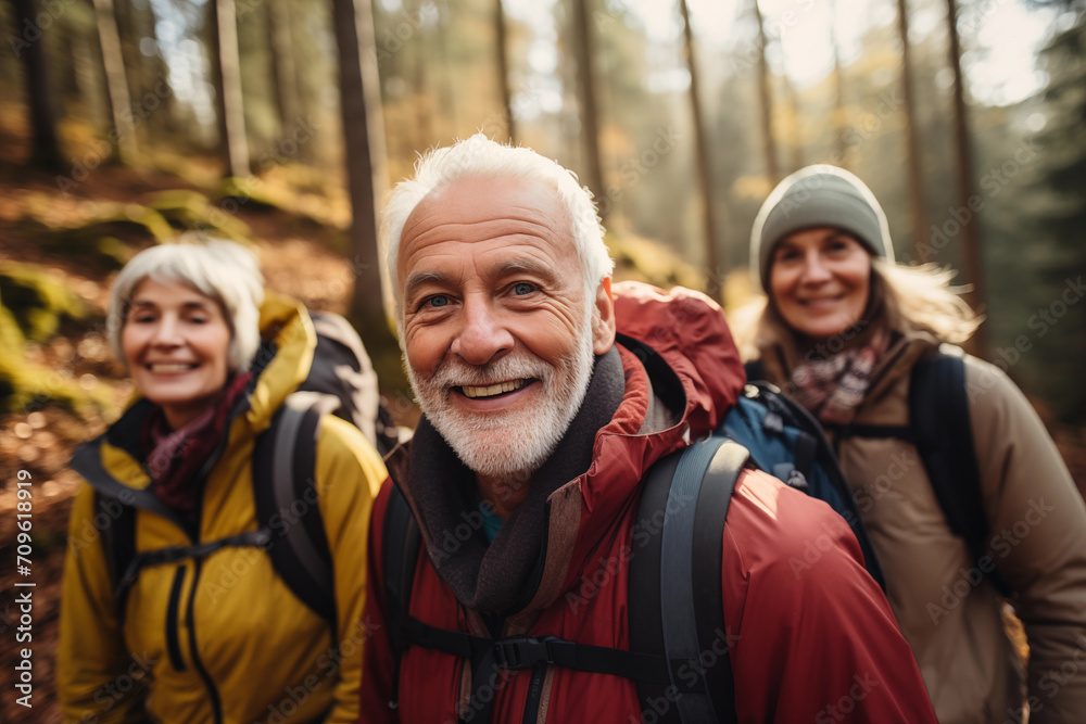 senior people group hiking in the forest in autumn, portrait looking at camera senior people group hiking in the forest in autumn, portrait looking at camera