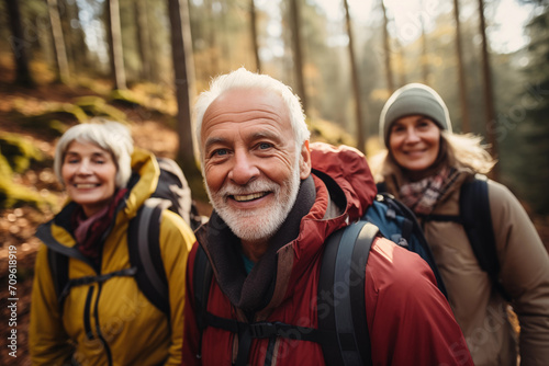 senior people group hiking in the forest in autumn  portrait looking at camera