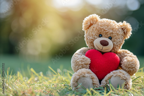 a cute Valentine teddy bear holding a romantic red love heart © ink drop