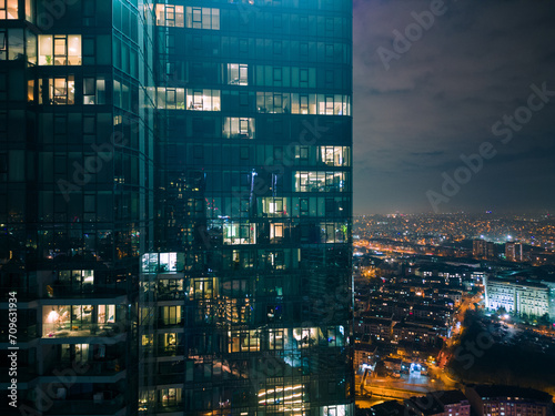 Istanbul s glass and concrete skyscrapers  home to offices  hotels  and residential complexes at night. Aerial drone view