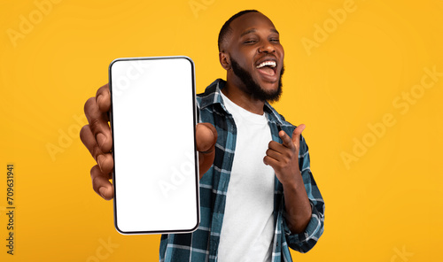 Black guy showing white empty smartphone screen, closeup