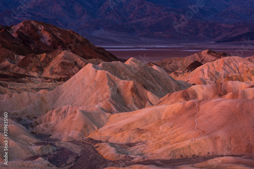 Mountains of sand in a dry valley in the evening © Sergey