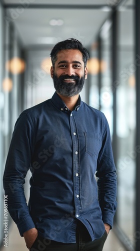 Professional smiling businessman manager executive or male employee or entrepreneur portrait. Happy bearded Indian business man leader looking at camera standing in office hallway, Generative AI