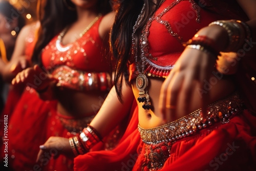 Belly dancers wearing a red costume with jewelery