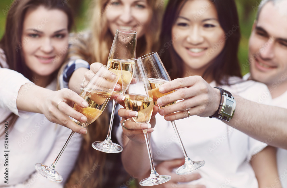 Celebration. People holding glasses of champagne making a toast outdoors Celebration. People holding glasses of champagne making a toast outdoors
