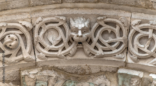 Décoration romane sur le linteau de l'entrée de l'abbatiale Saint-Michel de Nantua, Ain, France photo