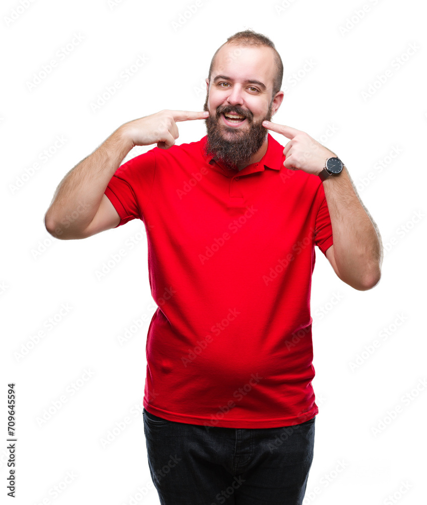 Fototapeta premium Young caucasian hipster man wearing red shirt over isolated background smiling confident showing and pointing with fingers teeth and mouth. Health concept.