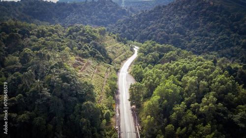 An aerial view of the road across the rainforest mountains in Hulu Selangor, Malaysia.