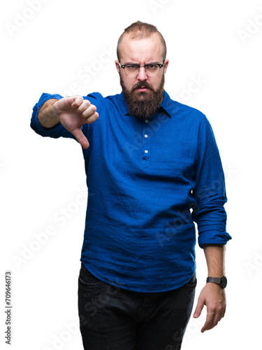 Young caucasian hipster man wearing glasses over isolated background looking unhappy and angry showing rejection and negative with thumbs down gesture. Bad expression.