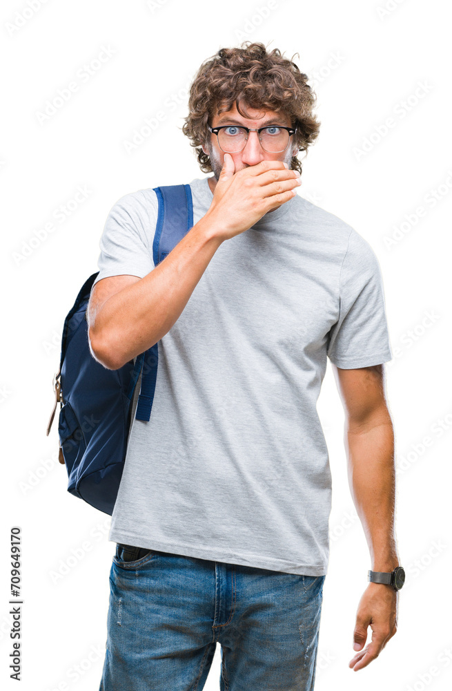 Handsome hispanic student man wearing backpack and glasses over isolated background shocked covering mouth with hands for mistake. Secret concept. Handsome hispanic student man wearing backpack and glasses over isolated background shocked covering mouth with hands for mistake. Secret concept.