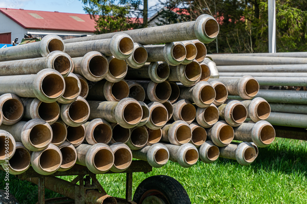 A lot of straight metal pipes, tubes loaded on a trailer A lot of straight metal pipes, tubes loaded on a trailer