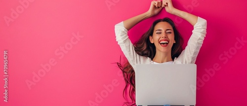 Euphoric Success: Woman Celebrating with Laptop on Pink Background.
