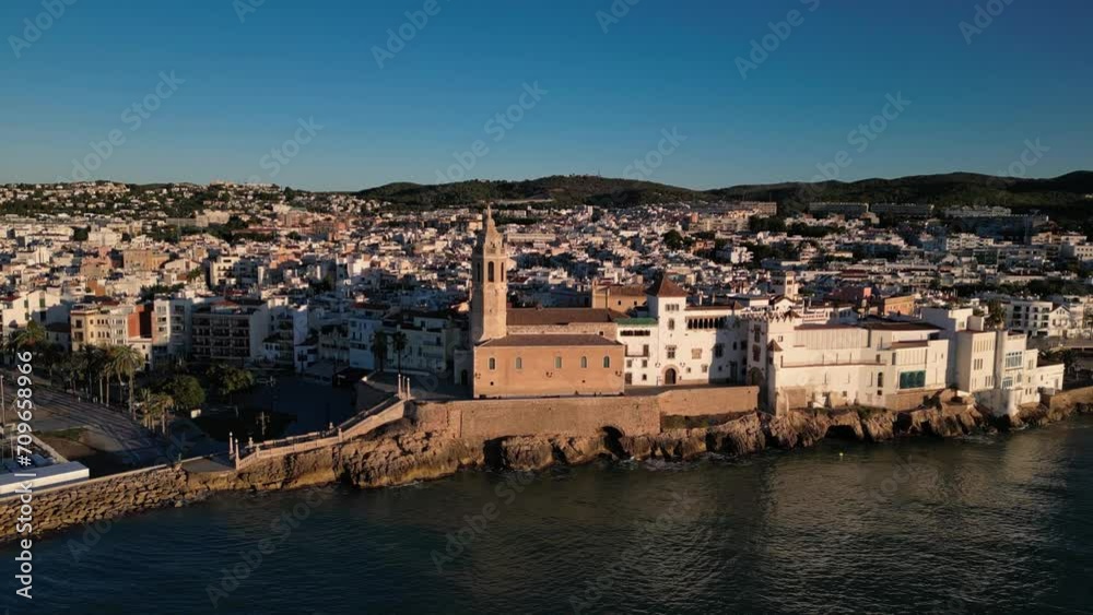 Sitges at sunrise. San Bartolome and Santa Tecla Church scene, Drone flight