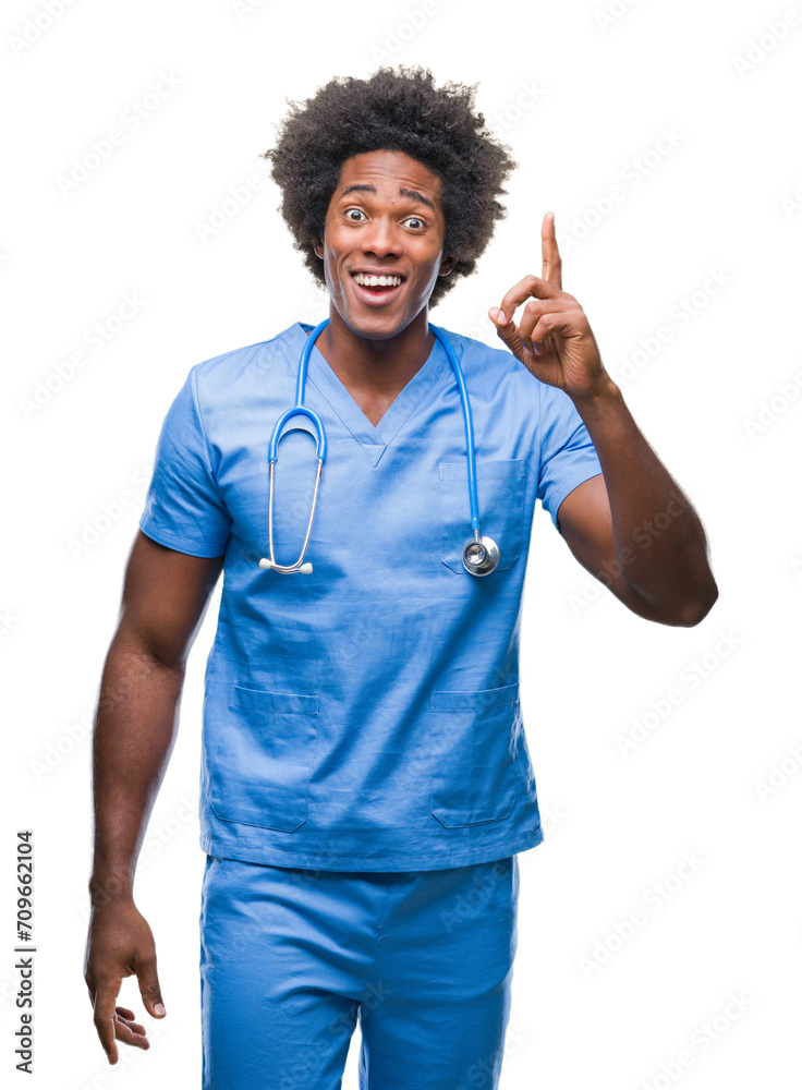 Afro american surgeon doctor man over isolated background pointing finger up with successful idea. Exited and happy. Number one.